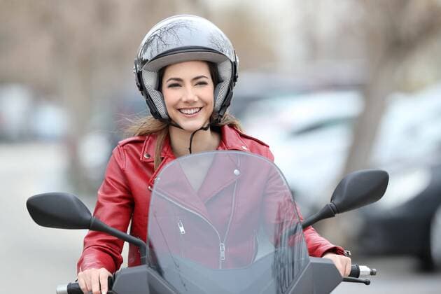  Woman driving a scooter on the street ,model released, Symbolfoto  Copyright: xAntonioGuillemx Panthermedia26586266