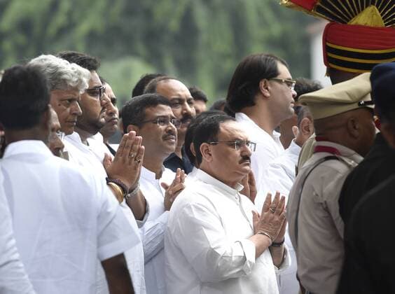 NEW DELHI, INDIA AUGUST 25: BJP President JP Nadda and BJP leader Dharmendra Pradhan pay their last respects to the mortal remains of former Finance Minister Arun Jaitley, at BJP Headquarter, on August 25, 2019 in New Delhi, India. Last rites of Arun Jaitley were performed at the Nigambodh Ghat in the national capital with full state honours. The senior leader of the ruling Bharatiya Janata Party (BJP) passed away on Saturday at the age of 66 due to prolonged illness. His body wrapped in the tricolour, Arun Jaitley was brought to Nigambodh Ghat in a flower-decked gun carriage from the BJP headquarters where thousands of people, leaders and diplomats whose lives he had touched and influenced had queued up to pay their respects. (Photo by Arvind Yadav Hindustan Times ) Last Rites Of Former Finance Minister Arun Jaitley Performed At Niga