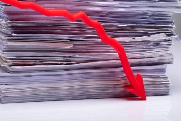  Red Decreasing Graph On Table Against Stack Paper  Copyright: xAndreyPopovx Panthermedia26832291