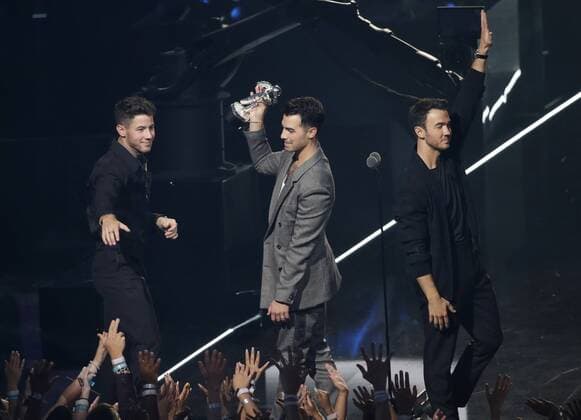 The Jonas Brothers react after winning an award at the 36th annual MTV Video Music Awards at the Prudential Center in Newark, NJ on Monday, August 26, 2019.  NJP20190821010 JOHNxANGELILLO