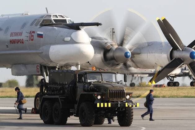 SARATOV REGION, RUSSIA - AUGUST 20, 2019: A Russian Air Force Tupolev Tu-95MS strategic bomber (front) at the Engels Airfield during a drill based on a scenario in which logistics units make the runway serviceable for Russian Air Force strategic bombers to take off following a drone attack and airstrike; the drill is taking place ahead of a broader logistical exercise by the Russian Armed Forces taking place across Russia s Central Military District. Anton Novoderezhkin TASS  TS0B854A
