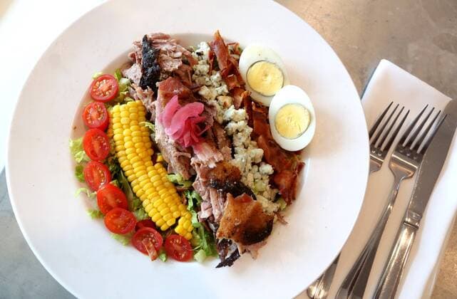 August 28, 2019, St. Pete Beach, Florida, USA: A Dewey Cobb Salad made with Barbecue Pork Shoulder, corn, applewood bacon, tomatoes, hard boiled egg, blue cheese, and poblano buttermilk vinaigrette dressing is offered at the Dewey Beach Restaurant in Pass-a-Grille. St. Pete Beach USA - ZUMAs70_ 20190828_zan_s70_038 Copyright: xScottxKeelerx