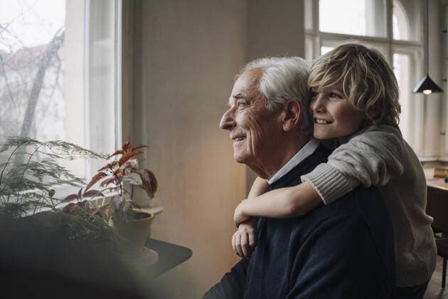 Happy grandson embracing grandfather at home model released Symbolfoto property released  GUSF02172