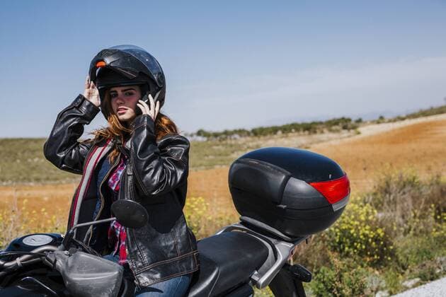 Motorcyclist putting helmet on, Andalusia, Spain model released Symbolfoto  LJF00362