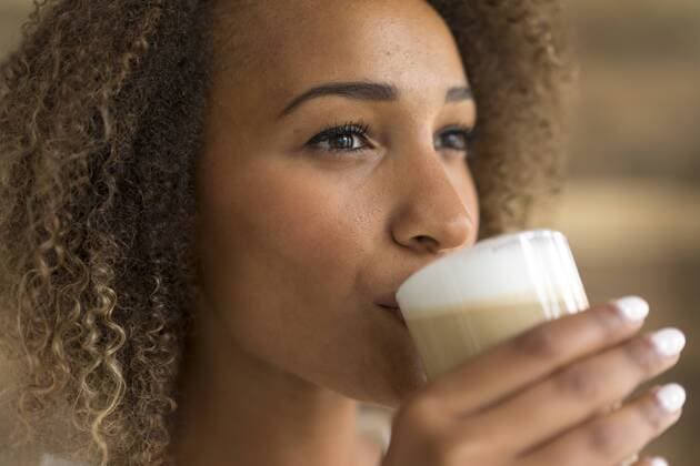Young woman drinking Latte Macchiato model released Symbolfoto property released  MOEF02351