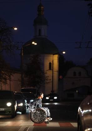 A disabled model in a wheelchair crosses a road via a zebra crossing as she wears a creation during the Safe Fashion performance at the Ukrainian Fashion Week SS20, Kyiv, capital of Ukraine, September 4, 2019. The performance showcased outfits by the finalists of the Safe Fashion Contest. Designers were to create collections of clothing and accessories with reflective elements to promote road safety. Ukrinform. Safe Fashion performance raises road safety awareness in Kyiv  Copyright: xDanilxShamkinx