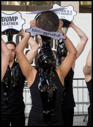 . 13 09 2019. London, United Kingdom. PETA Leather protest at London Fashion Week. PETA supporters pour buckets of black toxic slime over their heads at London Fashion Week to draw attention to the hazardous waste associated with the leather industry. Signs on the buckets read, Leather Is a Dirty Business and Dump Leather .  xMartynxWheatleyx xi-Imagesx IIM-20145-0003