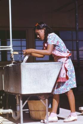 Young Woman at Community Laundry, Farm Security Administration (FSA) Camp, Robstown, Texas, USA, Arthur Rothstein for Farm Security Administration, January 1942 Editorial Use Only  Copyright: CircaxImages ghi-circa01599