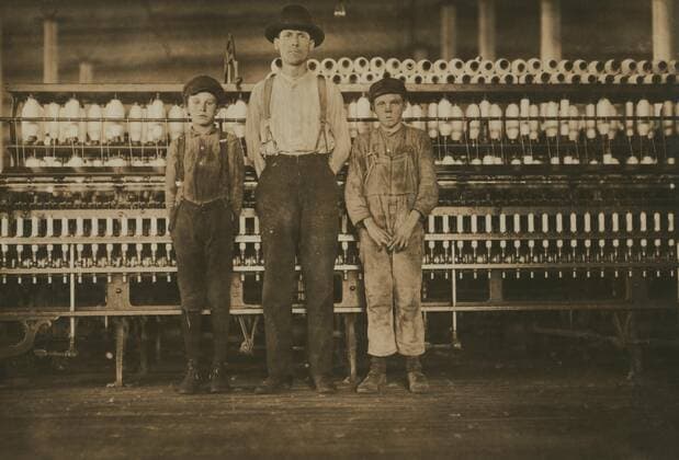 Overseer and Two Doffer Boys, Full-length Portrait, Avondale Cotton Mills, Birmingham, Alabama, USA, Lewis Hine for National Child Labor Committee, November 1910  Copyright: CircaxImages ghi-circa04215