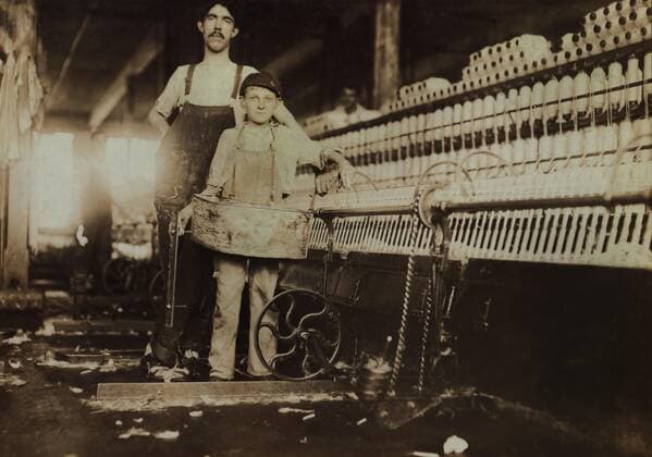 Young Tube Boy with Injured Finger and Overseer in Mule Room, Richmond Spinning Mill, East Lake, Chattanooga, Tennessee, USA, Lewis Hine for National Child Labor Committee, December 1910  Copyright: CircaxImages ghi-circa04220