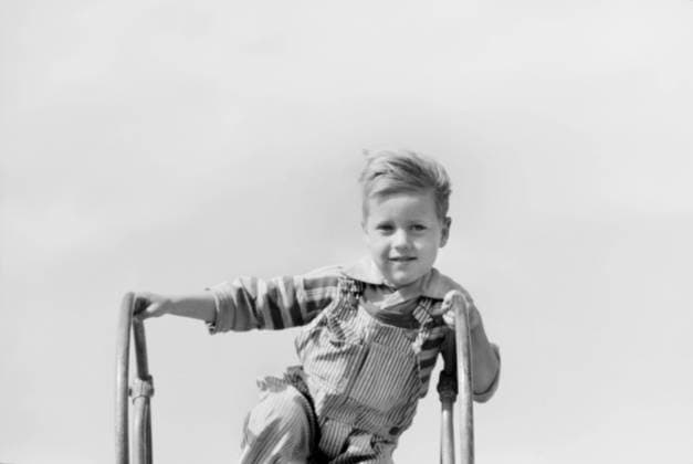 Portrait of Young Boy at Top of Playground Slide, Child of Migratory Worker, Weslaco, Texas, USA, Arthur Rothstein for Farm Security Administration, January 1942 Editorial Use Only  Copyright: CircaxImages ghi-circa04732