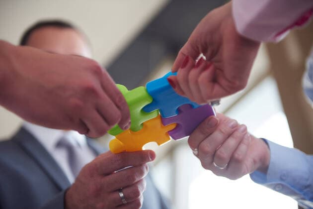 business people group assembling jigsaw puzzle and represent team support and help concept, top view perspective at modern bright office interior,model released, Symbolfoto ING_32193_105800