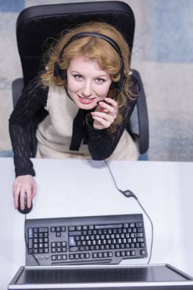 top view of a young smiling female call centre operator doing her job with a headset,model released, Symbolfoto ING_32193_152469