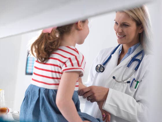 Female doctor examining and diagnosing a young girl in a clinic model released Symbolfoto property released  ABRF00617