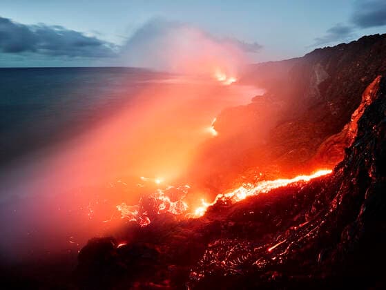 Glowing orange lava flowing from Pu u O o in sea at Hawaii Volcanoes National Park against sky  CVF01297