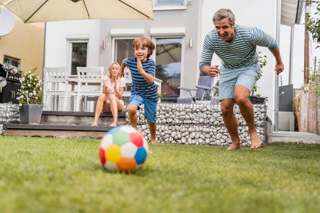 Father and son playing football in garden model released Symbolfoto property released  DIGF08242