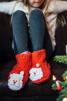 Close-up of girl wearing cozy Santa Claus footwear model released Symbolfoto  IPF00525