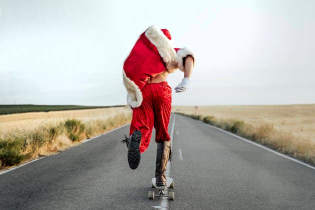 Santa Claus riding on longboard on country road model released Symbolfoto  JCMF00177
