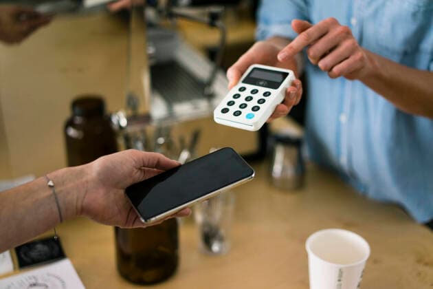 Customer paying contactless in a coffee shop model released Symbolfoto property released  JOSF03353