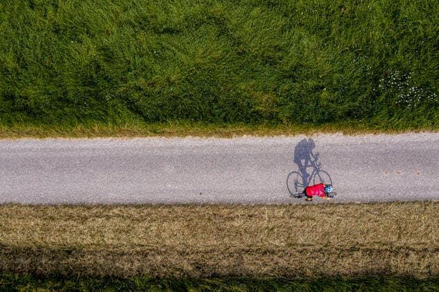 Triathlete riding bicycle on country road, Germany model released Symbolfoto  STSF02140