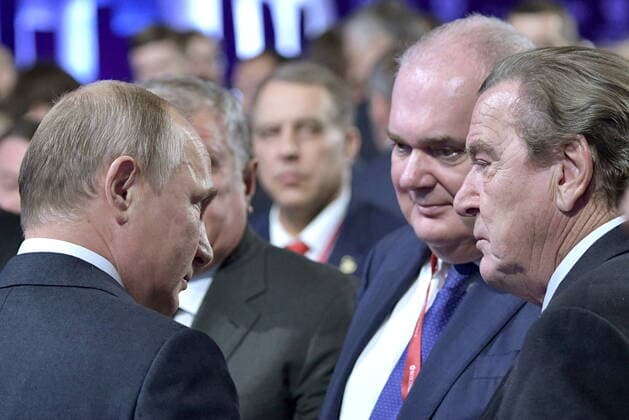 MOSCOW, RUSSIA - OCTOBER 2, 2019: Russia s President Vladimir Putin (L) and Gerhard Schroeder (R front), Chairman of the Nord Stream AG Shareholders Committee, attend the plenary session titled Energy Partnership for Sustainable Growth as part of the Russian Energy Week 2019 international forum at the Manege Central Exhibition Hall. Alexei Nikolsky Russian Presidential Press and Information Office TASS  TS0BD43C