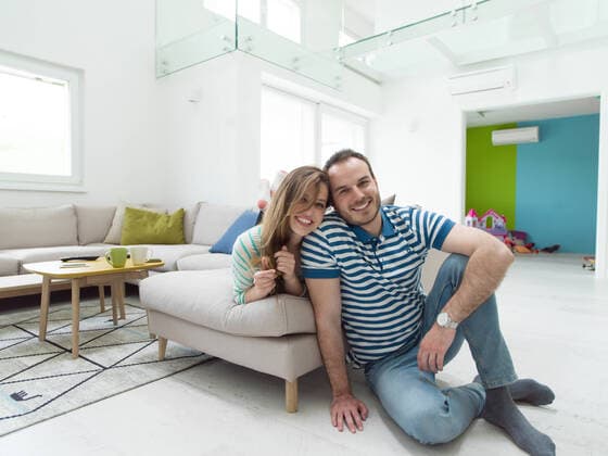young handsome couple enjoys hugging on the sofa in their luxury home villa,model released, Symbolfoto ING_32193_148525