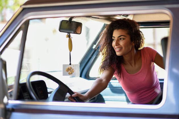 Arab woman inside an old van parked in a campsite in the middle of nature,model released, Symbolfoto INH_18944_06245