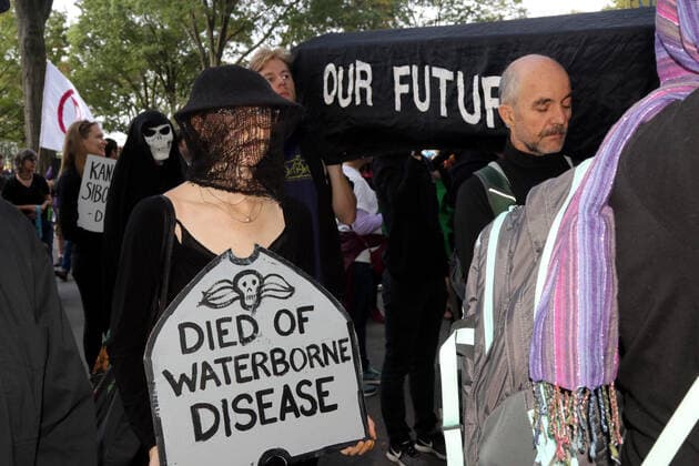 October 7, 2019, New York City, New York, US: Climate action group Extinction Rebellion launched a series of climate change protests around the globe on 7 October 2019, that featured large numbers of New York climate activists descending on lower Manhattan in actions that saw the iconic Charging Bull statute showered In Fake Blood and a die-in at the New York Stock Exchange on Wall Street, resulted in many arrests. New York City US - ZUMAl135 20191007_zap_l135_030 Copyright: xG.xRonaldxLopezx