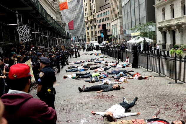 October 7, 2019, New York City, New York, US: Climate action group Extinction Rebellion launched a series of climate change protests around the globe on 7 October 2019, that featured large numbers of New York climate activists descending on lower Manhattan in actions that saw the iconic Charging Bull statute showered In Fake Blood and a die-in at the New York Stock Exchange on Wall Street, resulted in many arrests. New York City US - ZUMAl135 20191007_zap_l135_023 Copyright: xG.xRonaldxLopezx