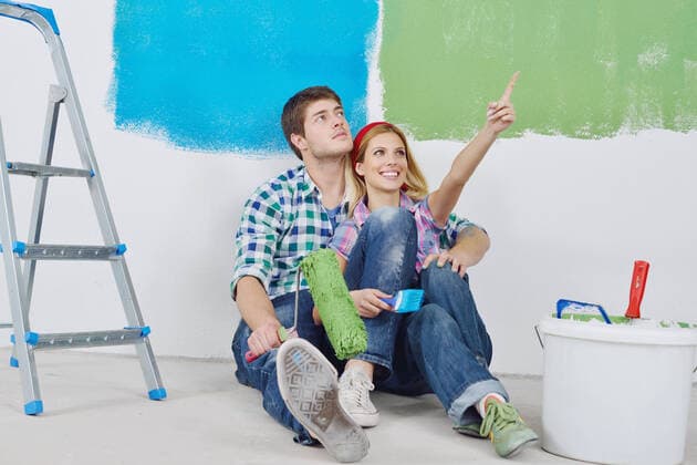 happy young couple relax after painting white wall in green and blue color in their new home,model released, Symbolfoto ING_32193_23190