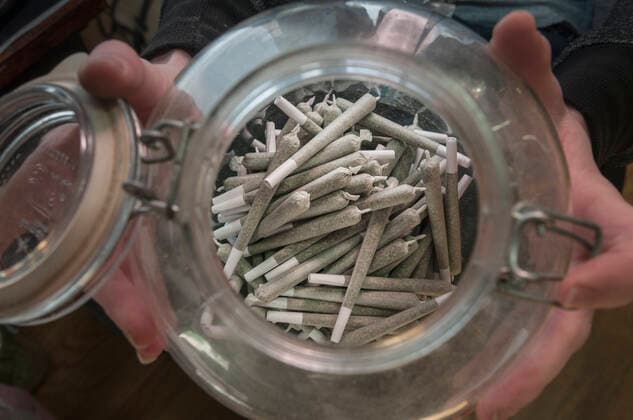 Rolled marijuana cannabis joints, in cannabis dispensary, Denver, Colorado, USA, June 2015. Marijuana has legalized in the state of Colorado, and this farm produces Marijuana for medical and retail purposes. Model and Property released.  1522715 JeffxRotman