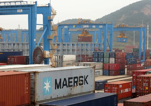 Autopilot trucks, guided by artificial intelligence, transport containers - offloaded by automated gantry cranes - to automated container cranes for delivery to designated areas at the Qingdao New Qianwan Automatic Container Terminal in Qingdao, Shandong Province, on Monday, October 14, 2019. Qingdao is home to Asia s first fully-automated port, a change which is likely to revolutionize the global shipping business. China currently operates seven of the world s busiest container ports, with Qingdao port ranking eighth in the world.  SDG2019101412 STEPHENxSHAVER