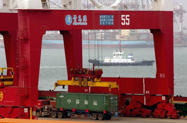 A truck is loaded with a container to be delivered to a designated area at the Qingdao New Qianwan Automatic Container Terminal in Qingdao, Shandong Province, on Monday, October 14, 2019. China currently operates seven of the world s busiest container ports, with Qingdao port ranking eighth in the world.  SDG2019101428 STEPHENxSHAVER