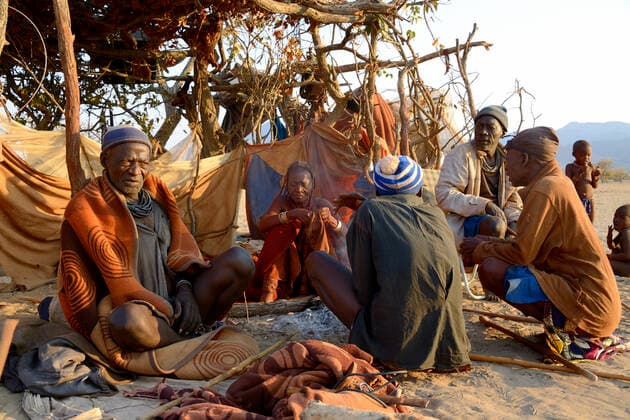 IMAGO Cultures of the world, Himba Volk in Namibia Elderly himba men and woman gathering in the morning in the village chief s hut, Marienfluss Valley, Kaokoland Desert, Namibia. October 2015  1531109 EricxBaccega