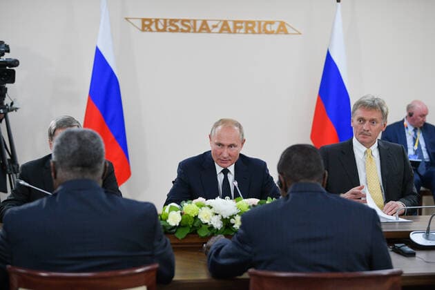 SOCHI, RUSSIA - OCTOBER 24, 2019 Russia s President Vladimir Putin (C) and Russian Presidential Spokesman Dmitry Peskov (R background) during a meeting with Guinea s President Alpha Conde on the sidelines of the 2019 Russia-Africa Summit at the Sirius Park of Science and Art. Alexei Druzhinin Russian Presidential Press and Information Office TASS  TS0C06B9