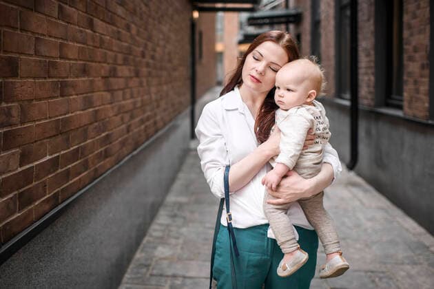 Mother holding her baby boy in an alley model released Symbolfoto  EYAF00552