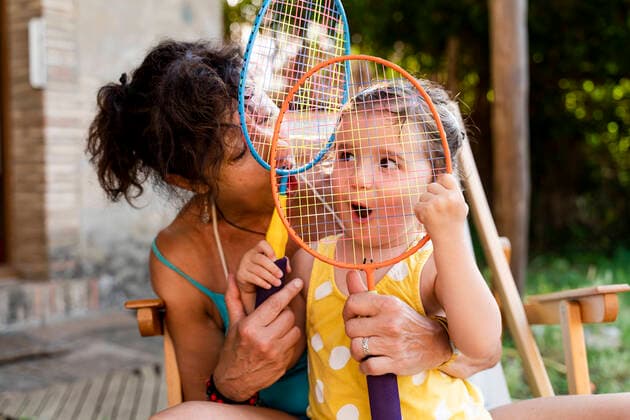Grandmother playing with little girl and badminton rackets outdoors model released Symbolfoto  GEMF03143