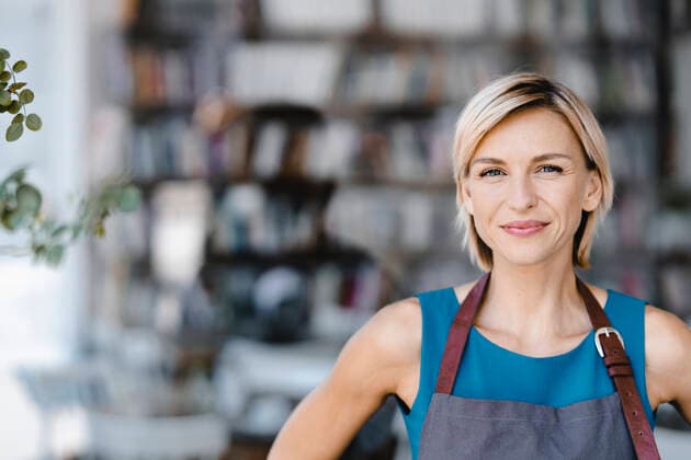 Portrait of blond woman, standing in front of her own coffee shop model released Symbolfoto property released  KNSF06323