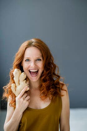 Portrait of excited redheaded woman with ginger root model released Symbolfoto property released  KNSF06533