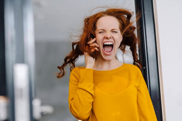 Screaming woman with windswept hair in office model released Symbolfoto property released  KNSF06607