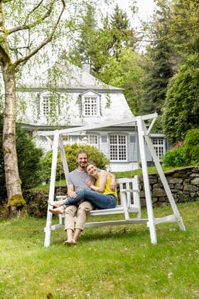 Happy couple relaxing in garden of their home model released Symbolfoto property released  MJFKF00079