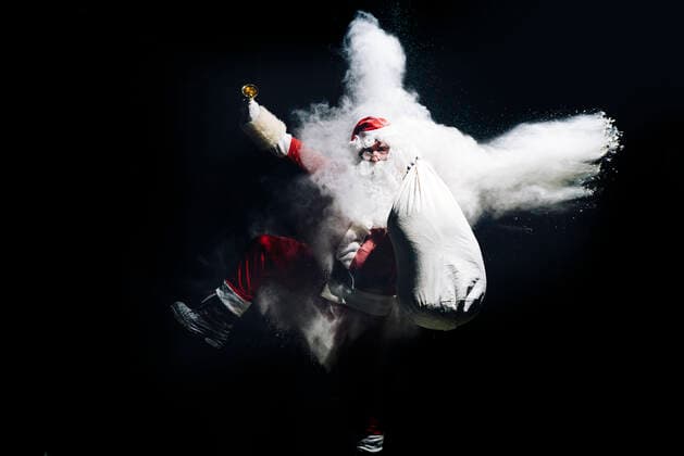 Santa Claus with exploding snow bomb against black background model released Symbolfoto  OCMF00748
