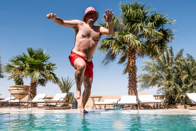 Overweight man jumping into swimming pool model released Symbolfoto  OCMF00792