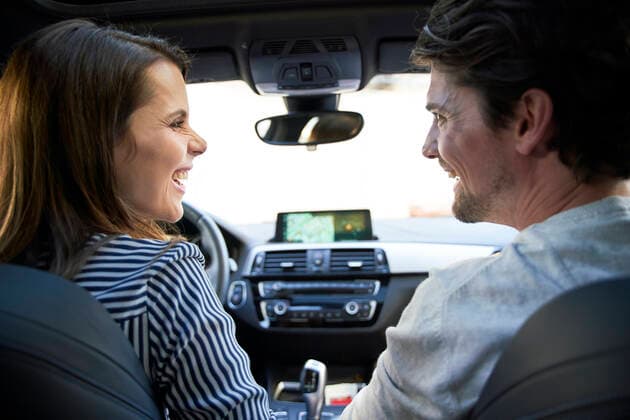 Happy couple in a car with woman driving model released Symbolfoto  PNEF01975