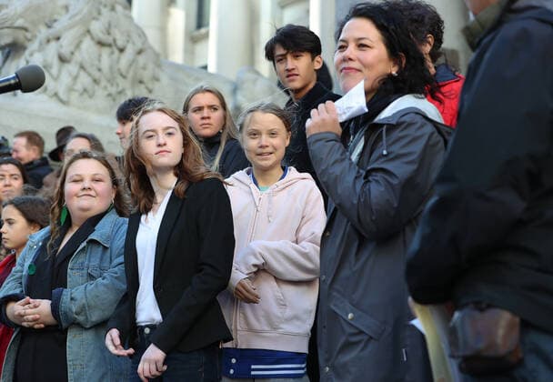 Swedish teen activist Greta Thunberg (pink) arrives for the post federal election Friday climate strike march starting and ending at the Vancouver Art Gallery in Vancouver, British Columbia on October 25, 2019. Organized by local youth-led, Sustainabiliteens, Greta and a turn out of nearly 10,000 climate activists demand action from industry and the various levels of government and are supporting the 15-youth who announced their plans to sue the federal government alleging it has contributed to climate change.  VAP2019102504 HEINZxRUCKEMANN