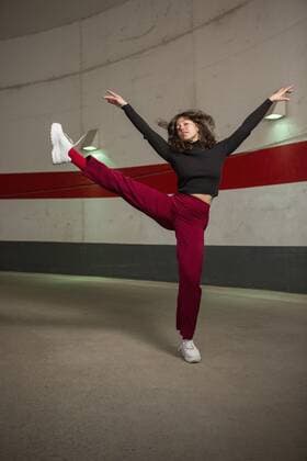 Portrait confident young woman dancing in tunnel Germany Berlin  Copyright: MarcoxBaass fStopImages1850024