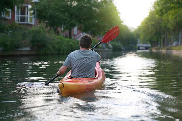 A person paddling along the suburban waterways of Utrecht, Netherlands Netherlands, Utrecht, Utrecht CR_GAWA191008B-207639-01