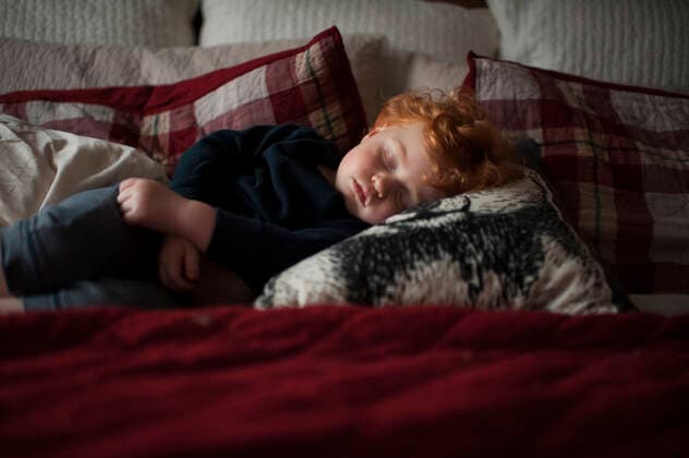 IMAGO Creative: Gesundheit, Stille Toddler boy 1-2 years old asleep on pillows in bed with red bedding United States, Iowa, Grimes CR_LIPF191014A-213634-01