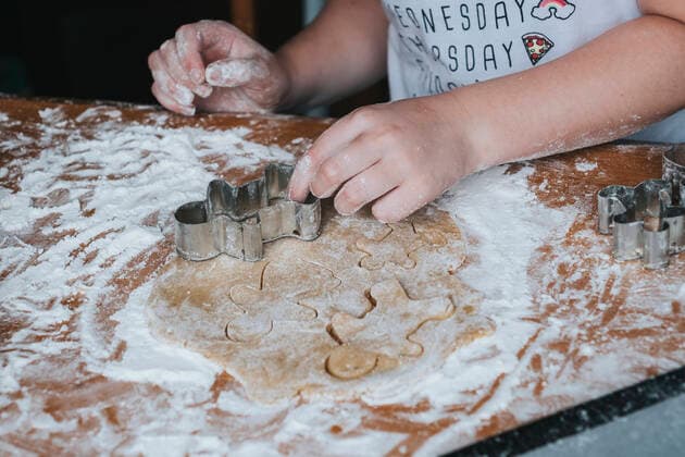 Close up of young girl cutting out gingerbread man from dough New Zealand, Taranaki, Hawera CR_LVBS191016-207949-01