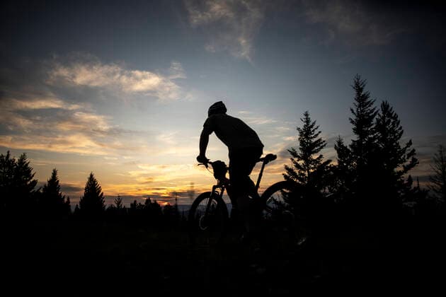 A mountain biker rides towards the sunset on top ofBlue Mountain United States, Montana, Missoula CR_NIEK191002A-205896-01